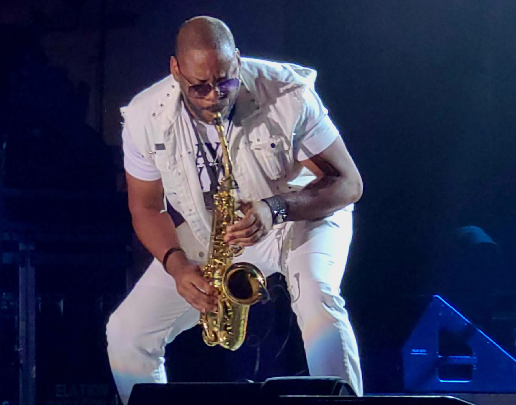 Jackiem Joyner performing on saxophone in a white vest