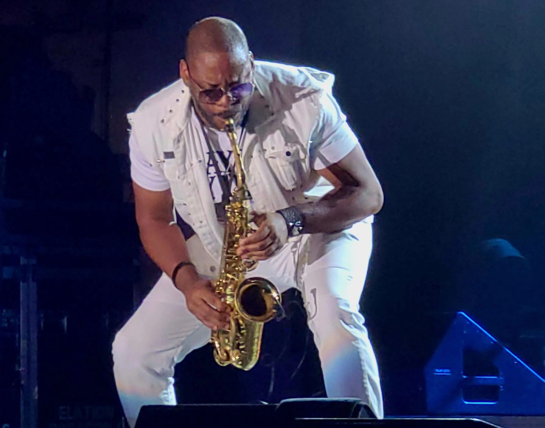 Jackiem Joyner performing on saxophone in a white vest